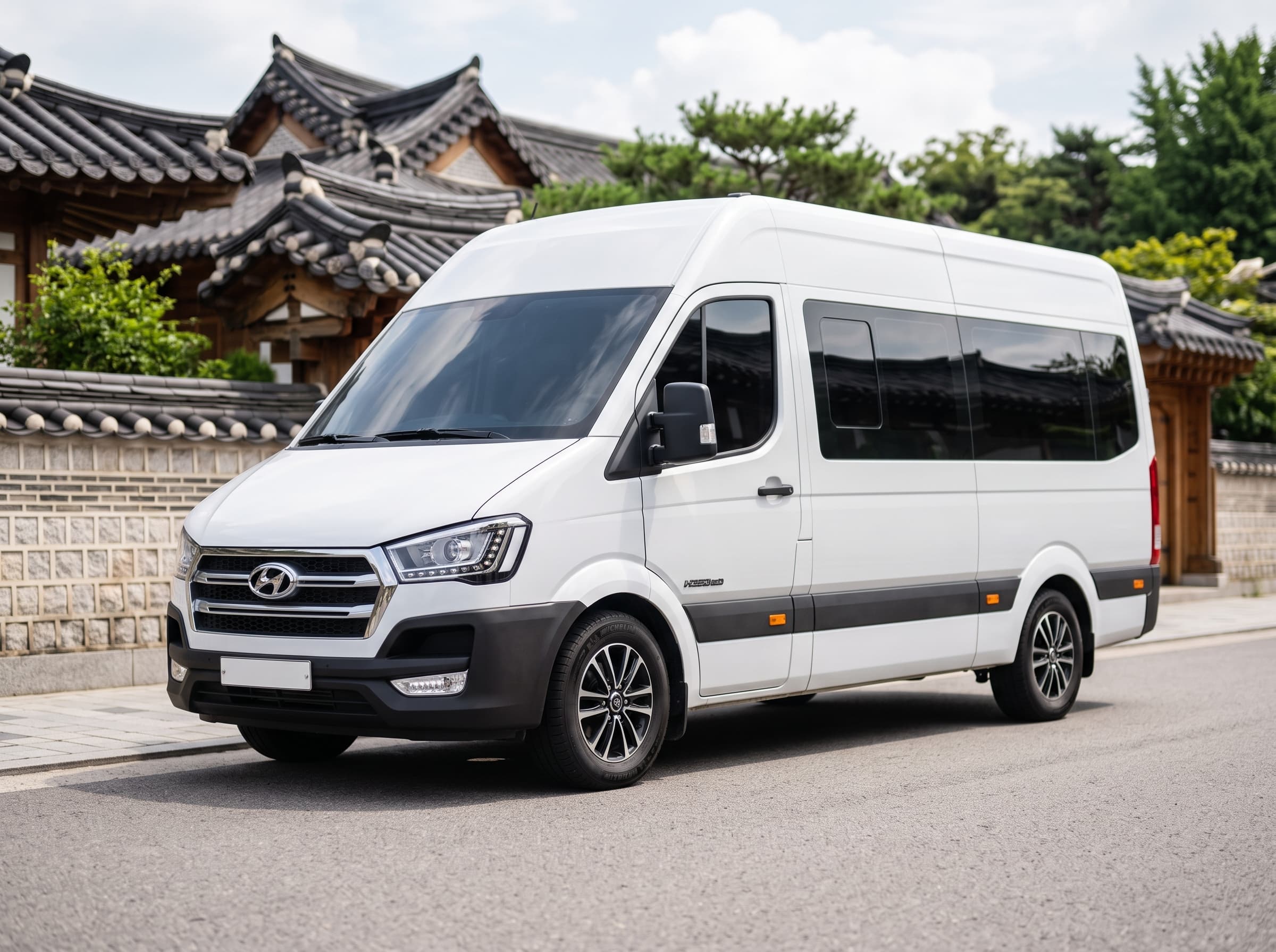 White Hyundai Solati high-roof passenger van parked beside traditional hanok houses in Seoul